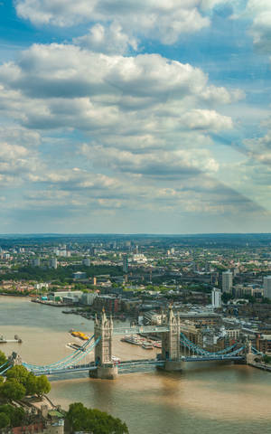 London's Tower Bridge Under Cloudy Sky Wallpaper