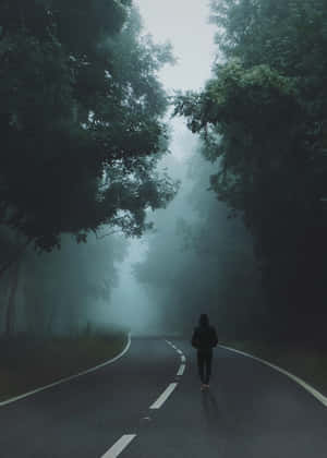 Loner Walking On Road Wallpaper
