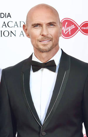 Luke Goss In A Suit And Ribbon Wallpaper