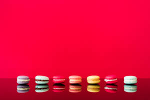 Macarons With Red Color Background Wallpaper