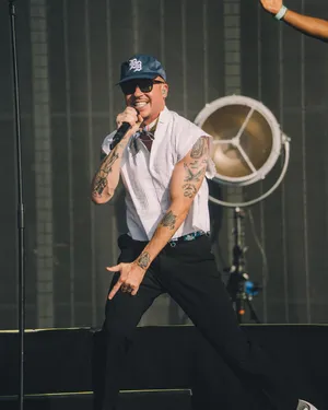 Macklemore Performing Liveon Stage Wallpaper