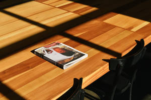 Magazine Placed On Wooden Table Wallpaper