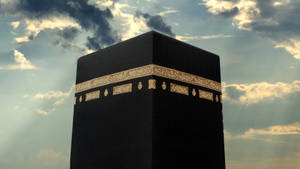 Majestic Close-up View Of Kaaba Under Dark Clouds Wallpaper