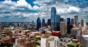 Majestic Dallas Skyline With White Clouds Wallpaper