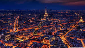 Majestic Eiffel Tower Illuminated At Night In Paris Wallpaper