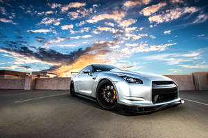 Majestic Nissan Skyline Gtr R35 Under The Cloudy Sky Wallpaper