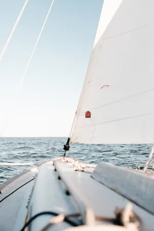 Majestic Sailboat On Tranquil Sea Wallpaper
