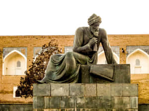 Majestic Statue Overlooking Ancient City Of Khiva Wallpaper