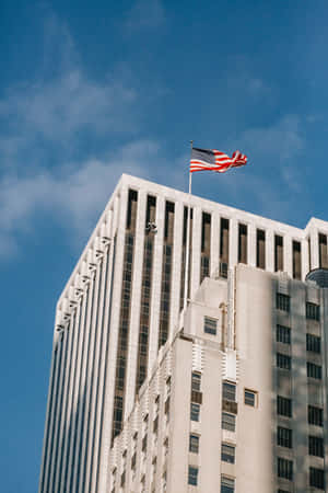 Majestic U.s. Flag Fluttering In The Sky Wallpaper