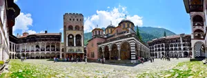 Majestic View Of Rila Monastery Under Clear Skies Wallpaper