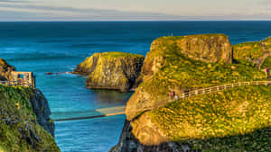 Majestic View Of The Carrick-a-rede Rope Bridge, Northern Ireland Wallpaper