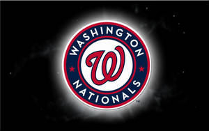 Majestic View Of The Iconic Washington Nationals Logo Shining In The Dark. Wallpaper