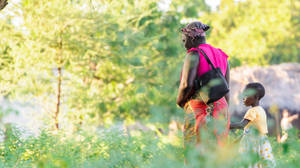 Malawi Woman Walking With Child Wallpaper