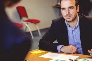 Male Teacher Listening To Parents Wallpaper