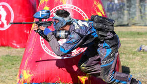 Man Beside Red Inflatable Paintball Bunker Wallpaper