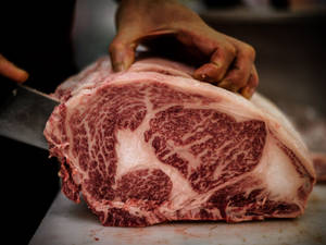 Man Cutting A Kobe Beef Wallpaper