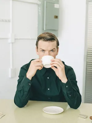 Man Drinking Coffeeat Table Wallpaper
