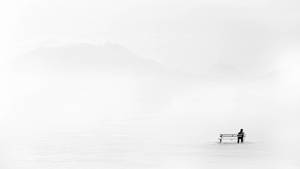 Man Embracing Solitude In Minimalist Setting Wallpaper