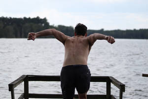 Man Flex Back Muscles Dive Wallpaper