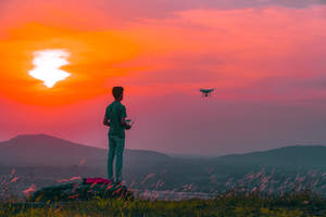 Man Flying Drone In Cambodia Wallpaper