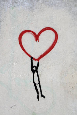 Man Hanging On Heart Wallpaper