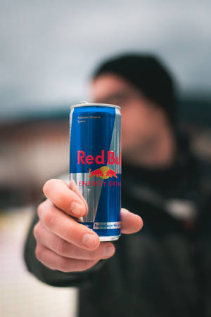 Man Holding Red Bull Can Wallpaper