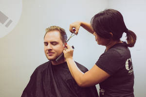 Man In Black Cape Gets Haircut Wallpaper