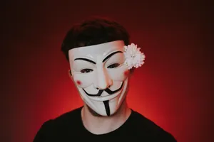 Man In Hacker Mask With Flower Wallpaper