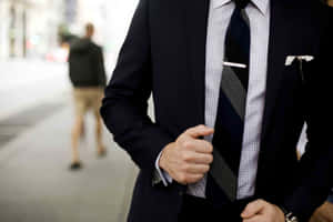 Man In Suit Touching His Coat Wallpaper