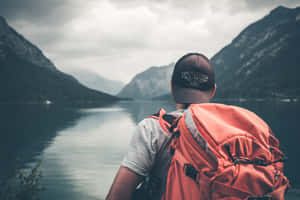 Man On A World Travel Exploring Lake Wallpaper