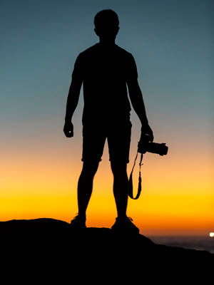 Man On Cliff During Sunset Photography Wallpaper
