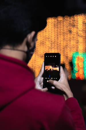 Man Photo Editing On Mobile Wallpaper