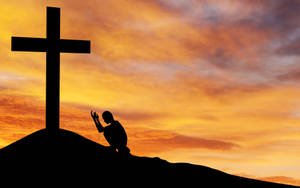 Man Praying To Cross Of The Christian God Wallpaper