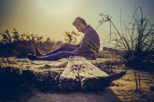 Man Sitting Alone On The Ground Wallpaper