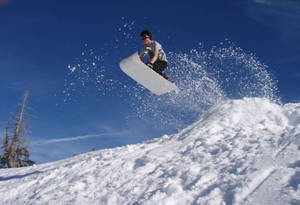 Man Sledding Jump Wallpaper