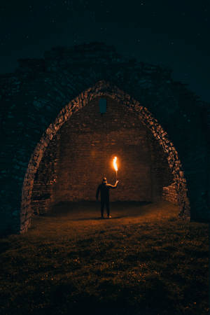 Man With Torch In Horror Castle