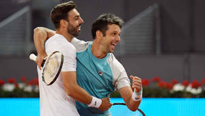 Marcel Granollers In A Celebratory Hug With Horacio Zeballos Wallpaper