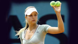 Maria Kirilenko In Action With Two Tennis Balls Wallpaper