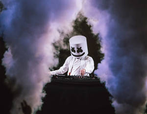 Marshmello Performs On A Stage Filled With Smoke Wallpaper
