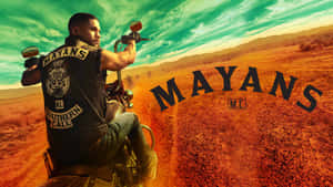 Mayans - A Man Riding A Motorcycle In The Desert Wallpaper