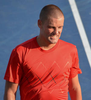 Mikhail Youzhny In Action - The Russian Tennis Maestro In Red Wallpaper