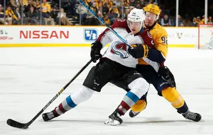 Mikko Rantanen Leaning And Falling Against Player From Nashville Predators Wallpaper