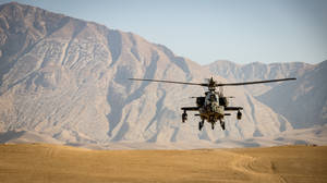 Military Helicopter Landing On Sand Wallpaper