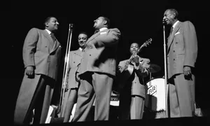 Mills Brothers Performingon Stage Wallpaper