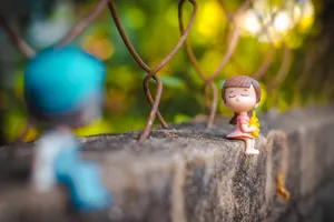 Mini Cute Doll Couple On Gate Wallpaper