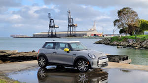 Mini White Car By Ocean Side Wallpaper