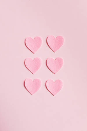 Minimalist Hearts On Pastel Pink Colors Wallpaper