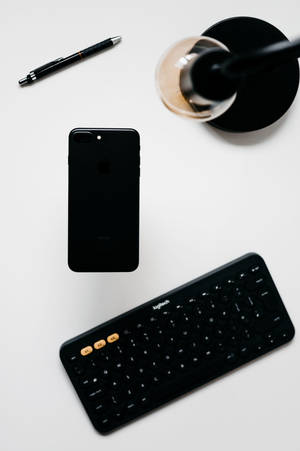 Minimalist Iphone Desk With Black Keyboard Wallpaper