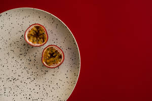 Minimalist Passion Fruit On Plate Presentation Wallpaper