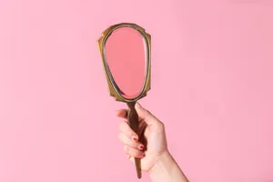 Mirror On Pastel Pink Color Background Wallpaper